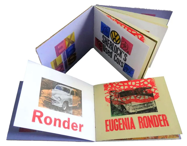 Sherlock’s Used Cars open at a page for Eugenia Ronder with a printed car.