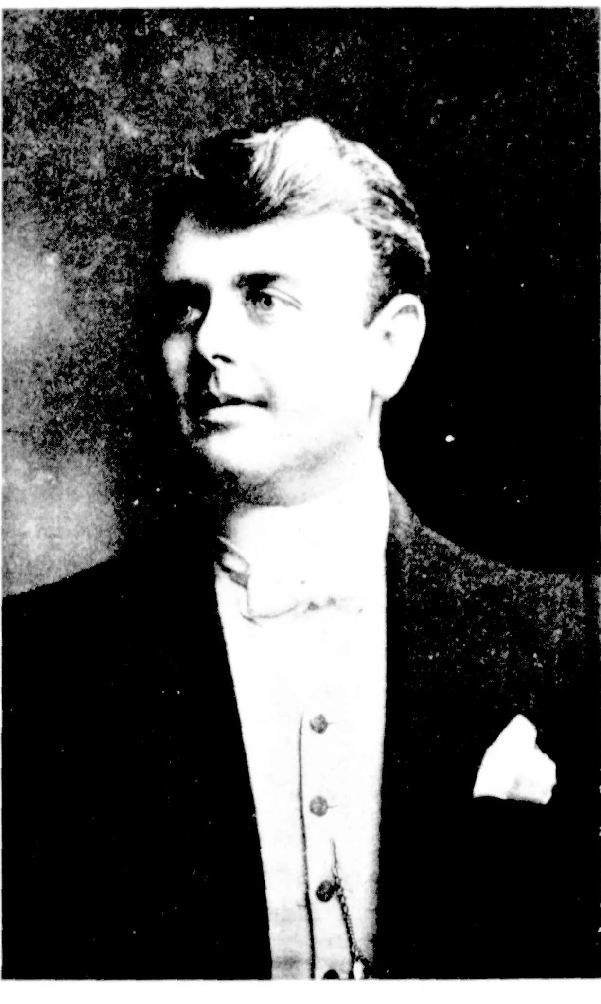 Harry Plimmer, head and shoulders, three-quarters to the left: fair wavy hair, evening dress, a white waistcoat and a handkerchief in his breast pocket.